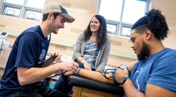 A photo of students in the College of Education and Human Development utilizing the Lengyel Gym training resources.