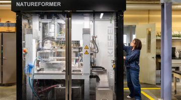 A photo of a person next to a large machine