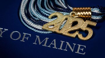 An image of a 2025 tassel and a diploma holder