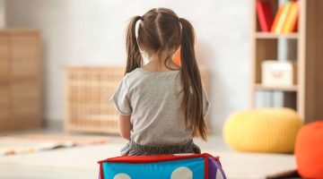 A stock image of a girl sitting on a box