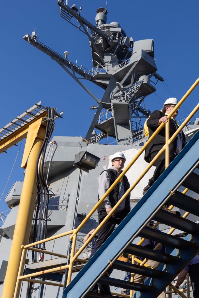 A photo of people walking up stairs at Bath Iron Works