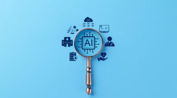A stock image of a magnifying glass, with "AI" and tech logos