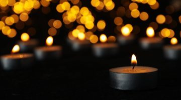 A photo of candles in the dark