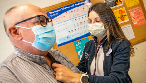 A photo of a nurse checking on a patient