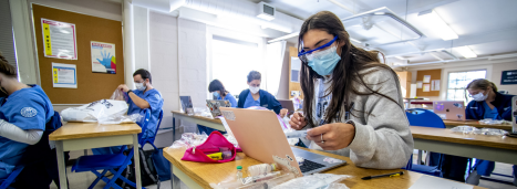 A photo of a nursing student on her laptop.