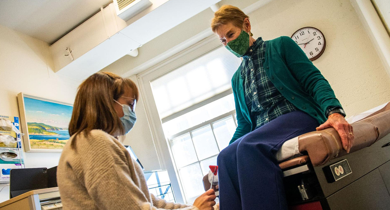 A photo of a nurse checking on a patient