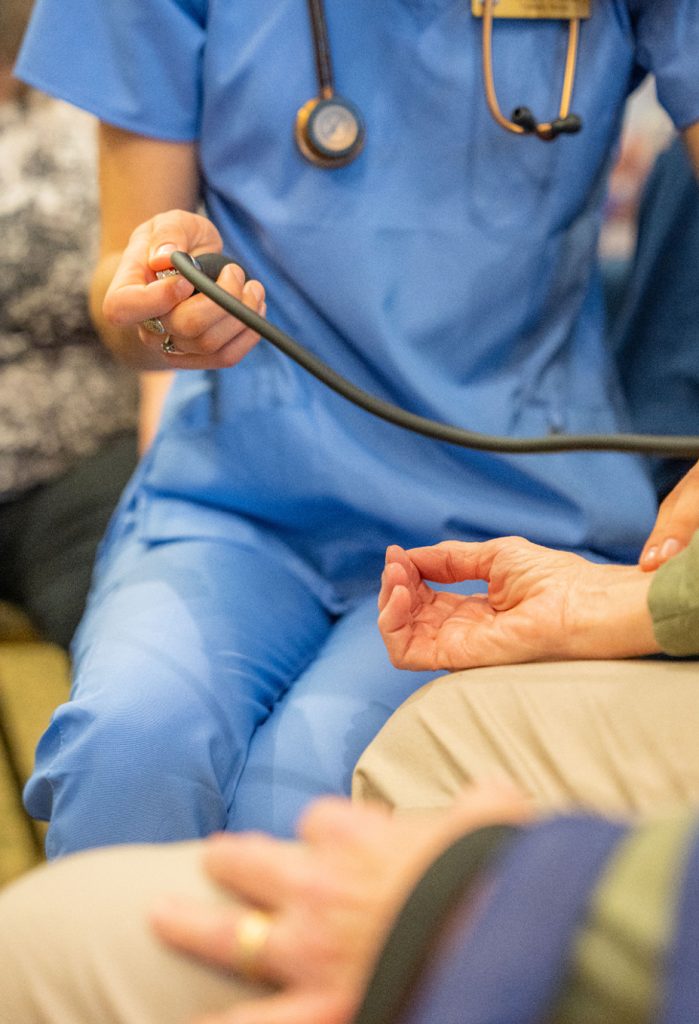 A photo of a nursing student using a stethoscope