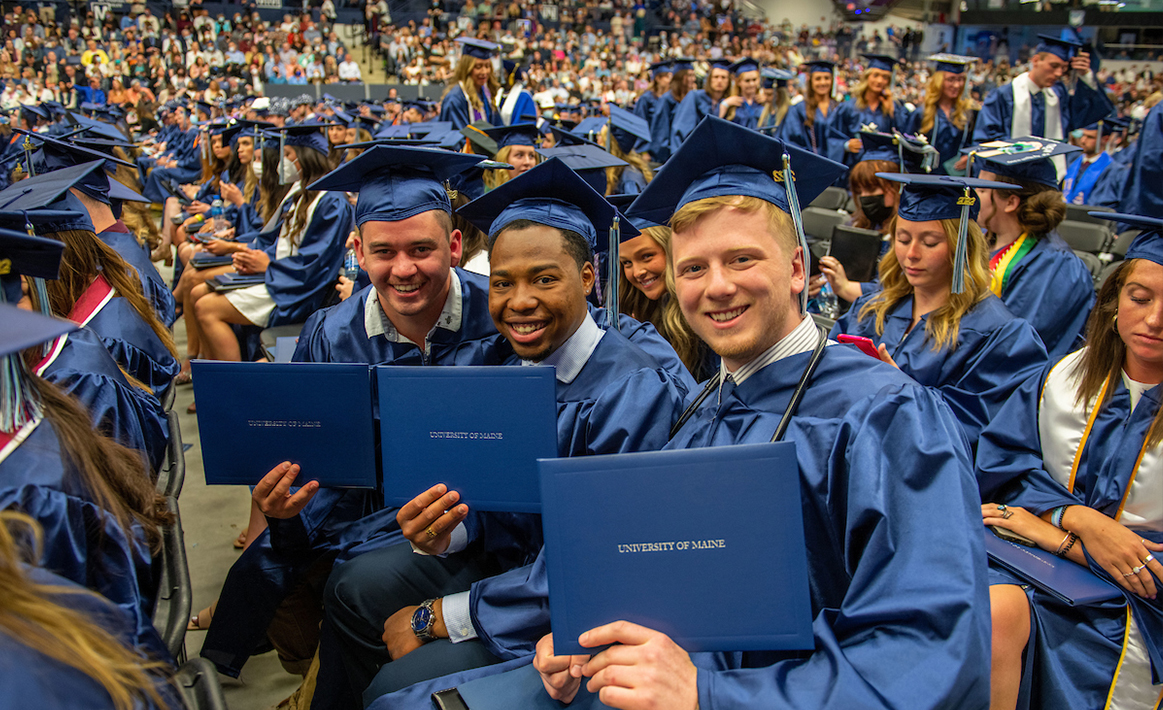 A photo of three male nursing graduates at graduation