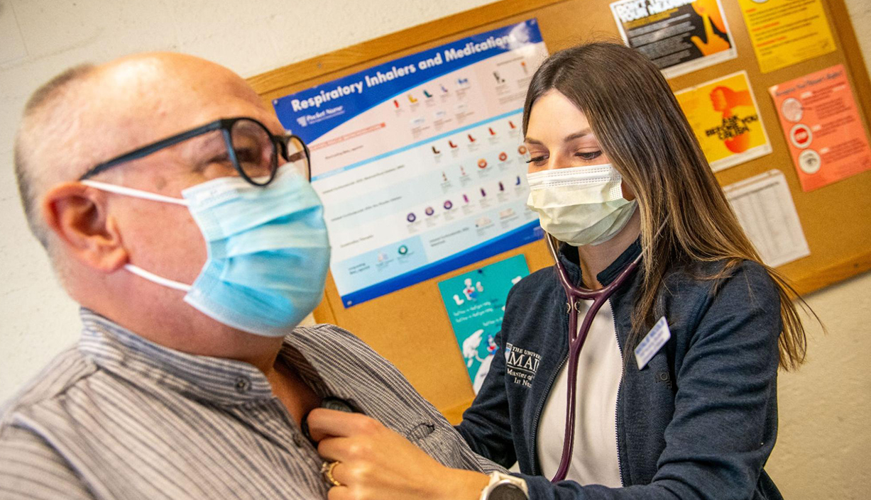 A photo of a nurse checking on a patient