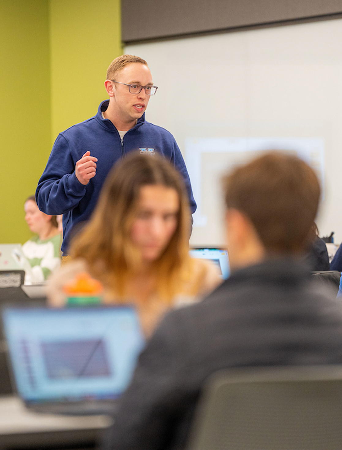 A photo of a nursing professor teaching to students