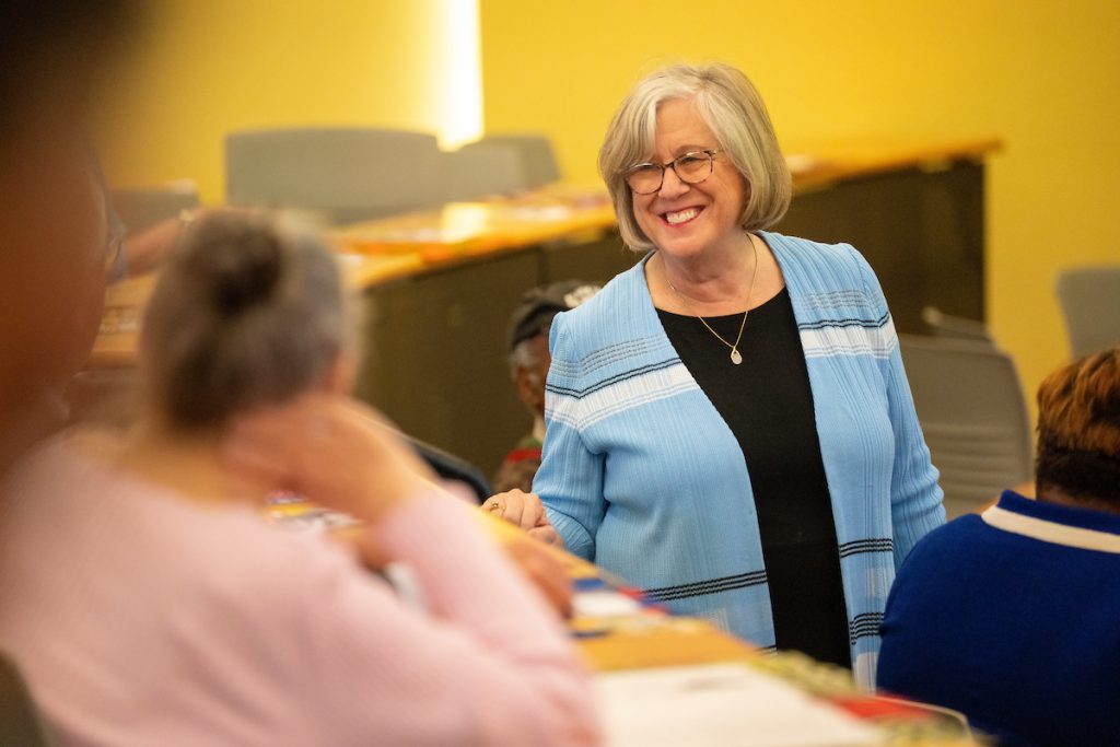 A photo of President Ferrini-Mundy talking to a group