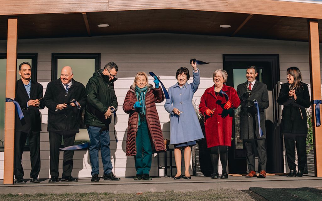 A photo of President Ferrini-Mundy, Susan Collins and Janet Mills cutting a ribbon in front of the 3D printed house
