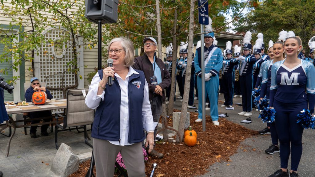 A photo of the president with cheerleaders in the background
