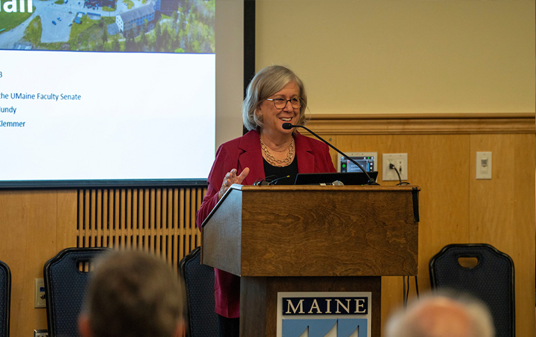 A photo of President Ferrini-Mundy speaking at a podium