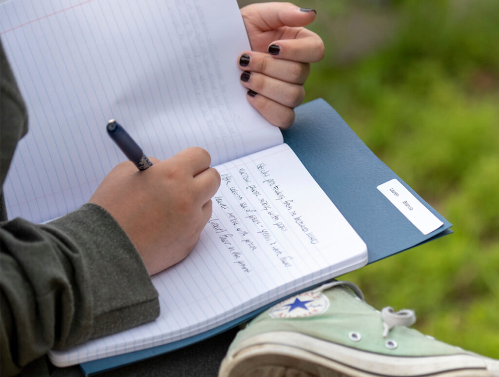 Person taking notes in notebook