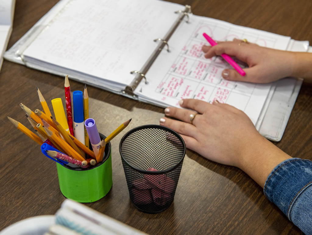 A photo of hands on a planner