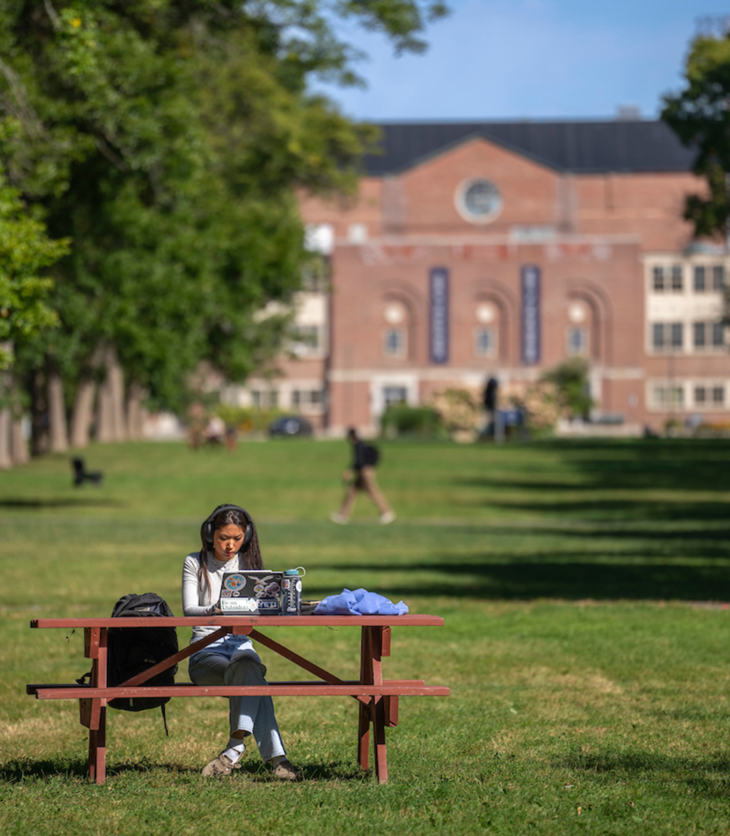 A photo of a student studying outside