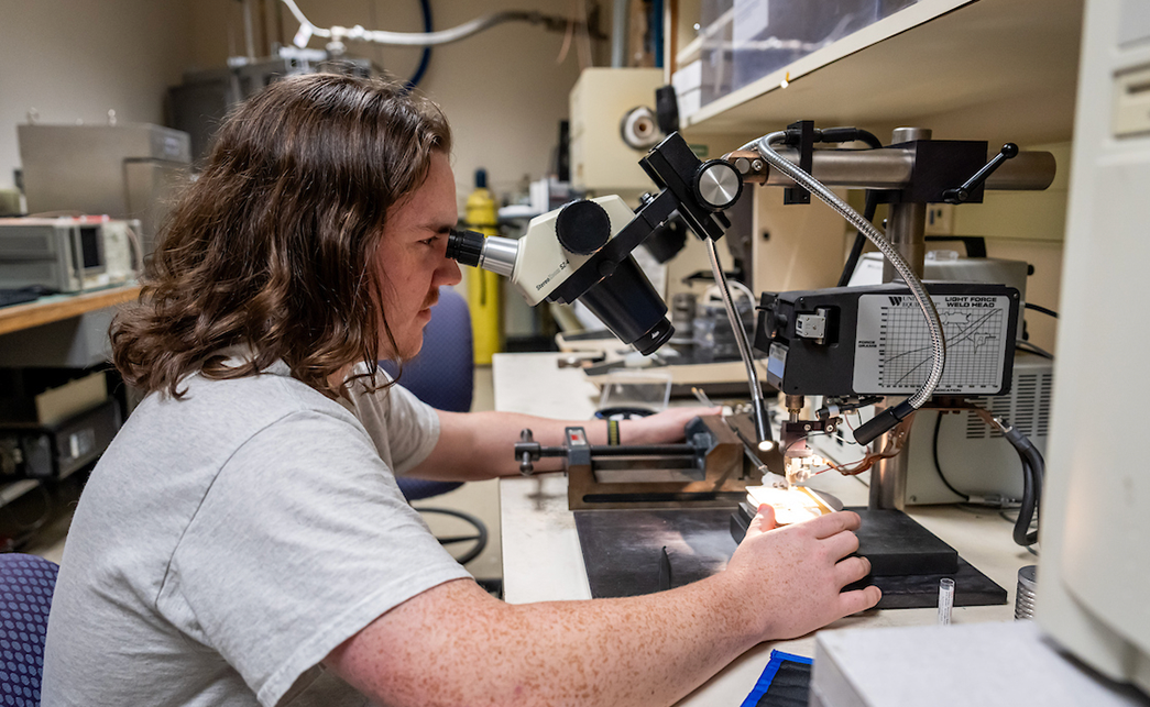 A photo of a student looking through a microsope