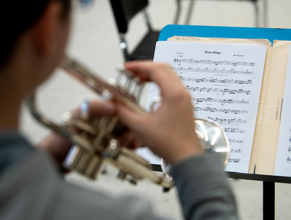 A photo of a student playing the trumpet