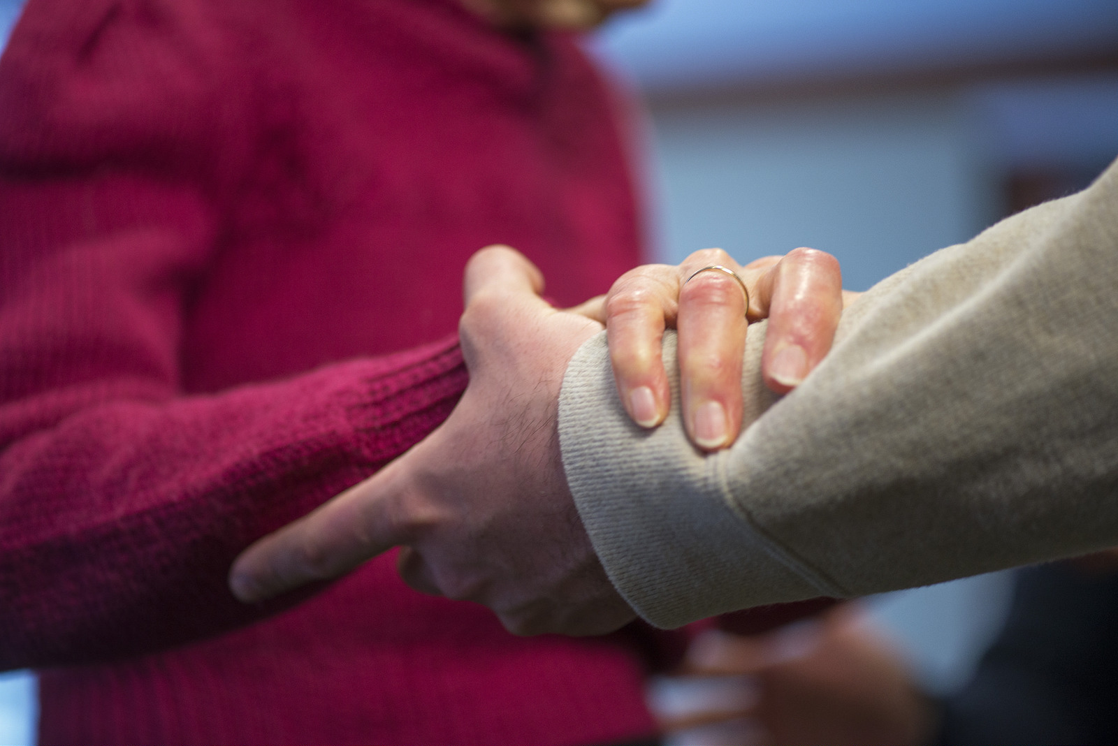 Elderly woman hold hand with man