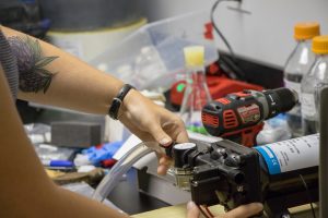 Meghan Amico works on assembling parts of the continuous high frequency monitoring device.