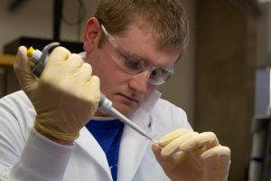 James Elliott works with DNA samples in the lab