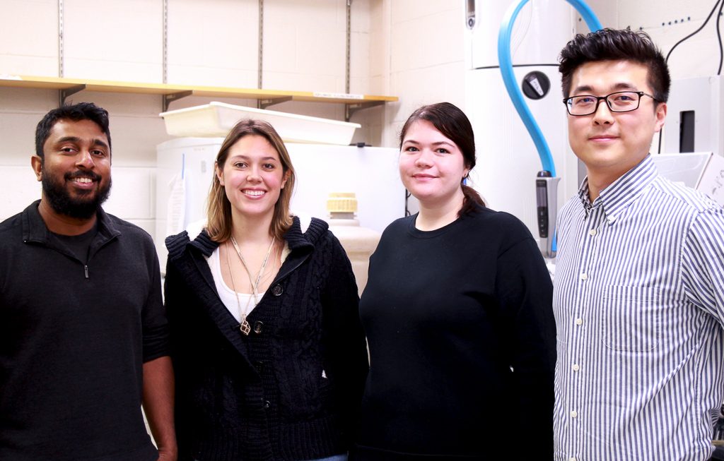 Jayasundara and Wei in lab with students