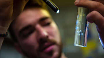 Student holding sample