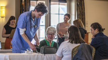 picture at an event for seniors showing nurses helping