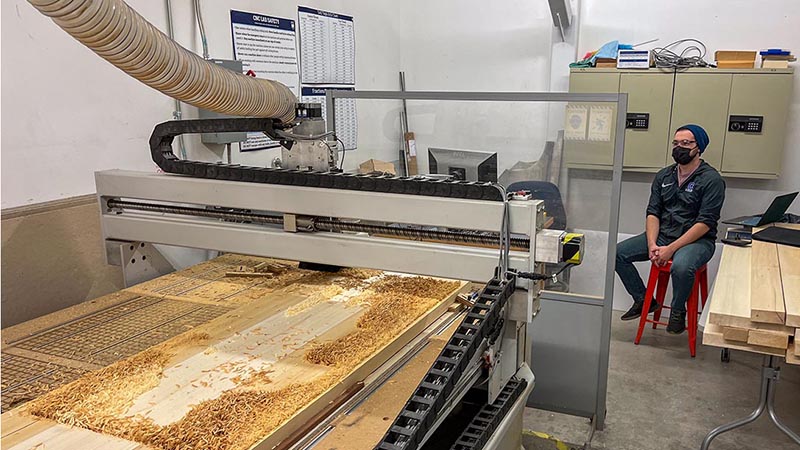 A photo of a machine carving wood at the IMRC Center