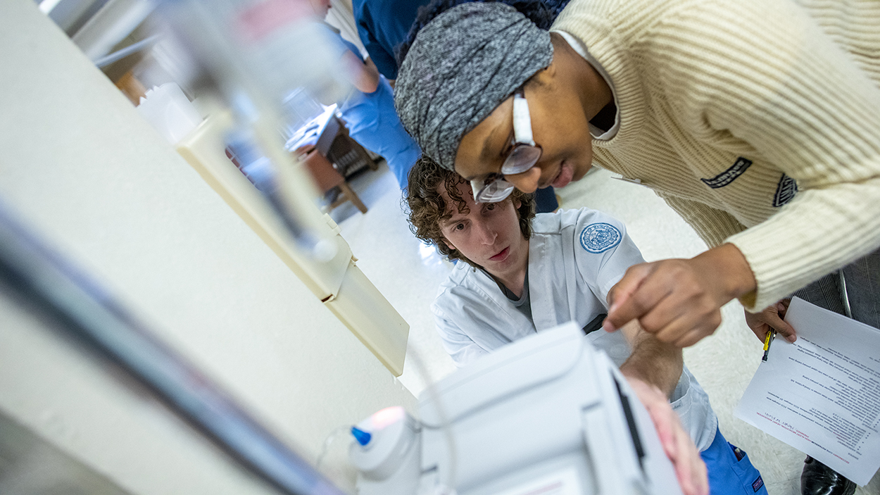 School of Nursing students learn how to flush IVs for patients.