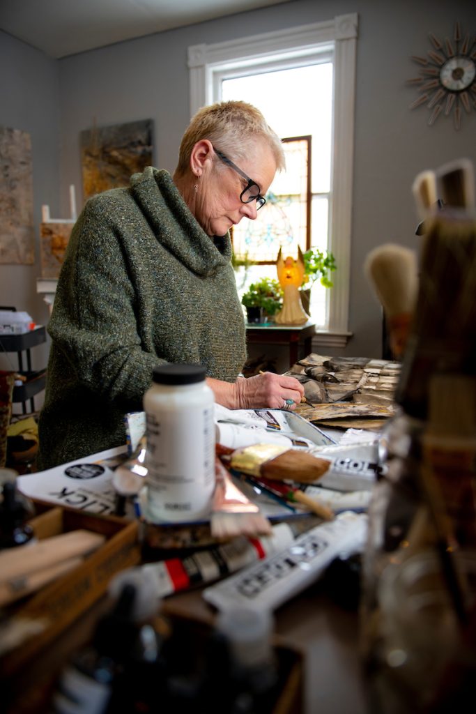 Susan Smith working in her art studio.