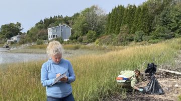 Yoder and her adviser gather trash on the Maine coast