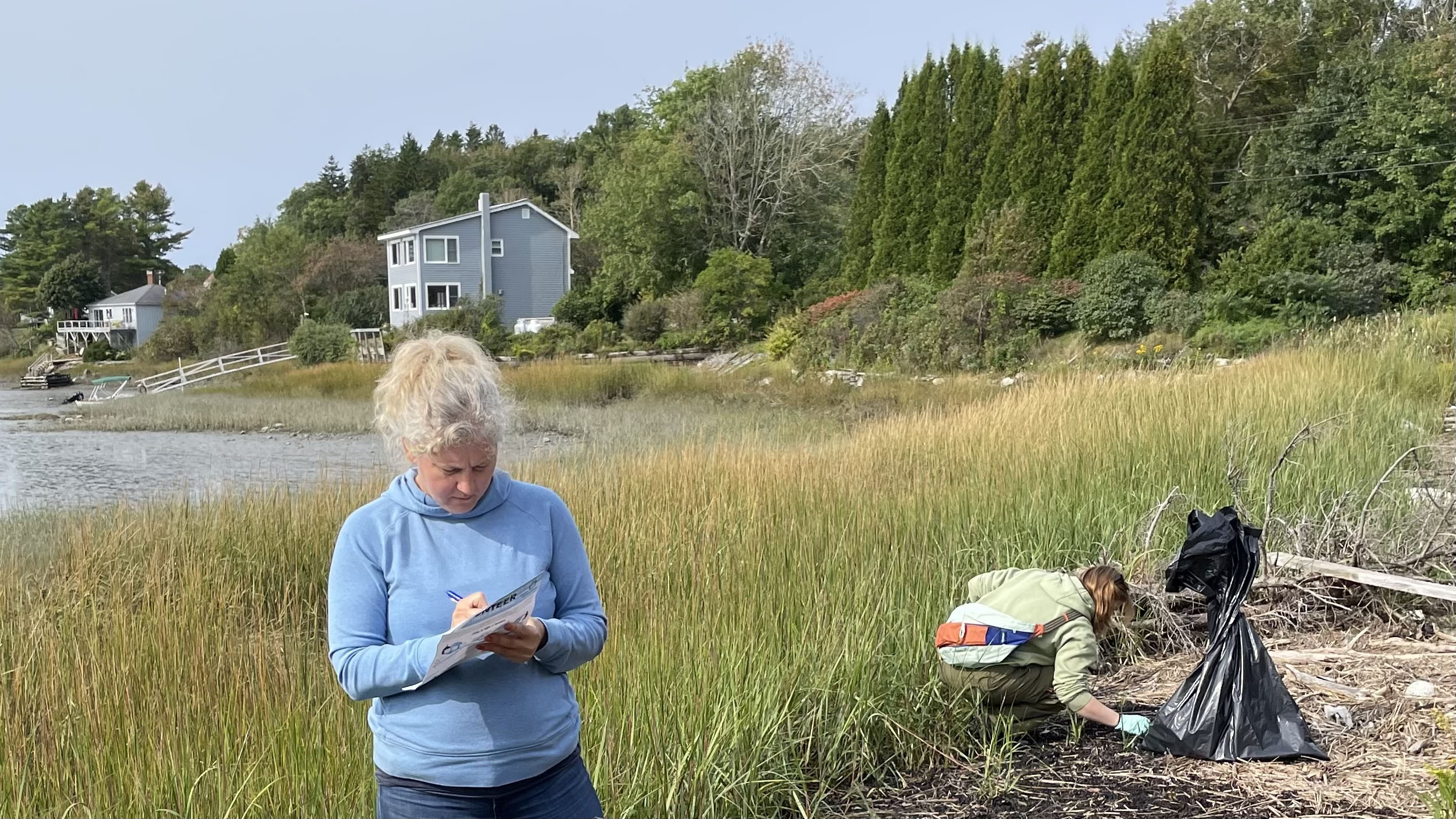 Yoder and her adviser gather trash on the Maine coast