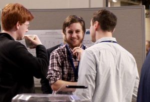 Students talking at the Symposium