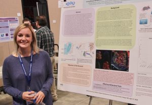 student in front of poster