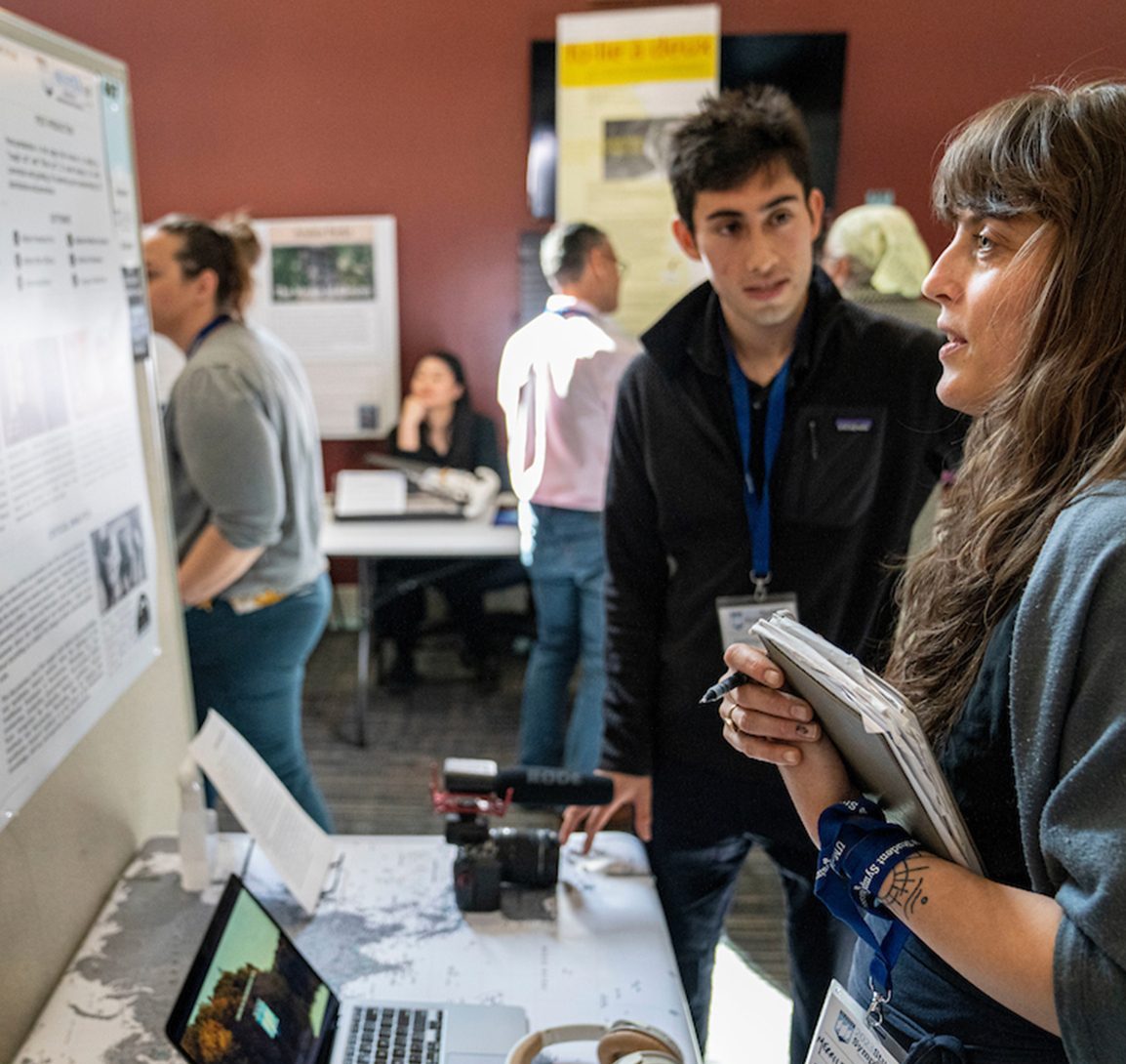 A photo of a student presenting at the symposium