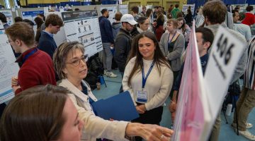Students view presentations during the 2025 UMaine Student Symposium, held at the New Balance Field House on the UMaine campus on Friday, Apil 11, 2025.
