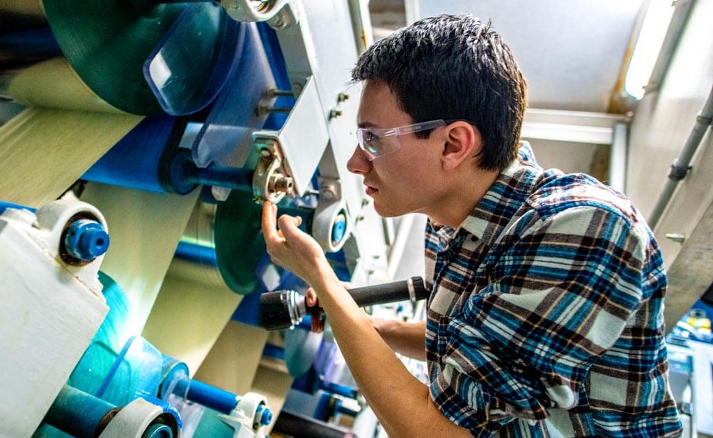 A photo of an engineering student working in the pilot plant